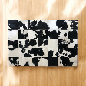 Cow print patchwork rug in room